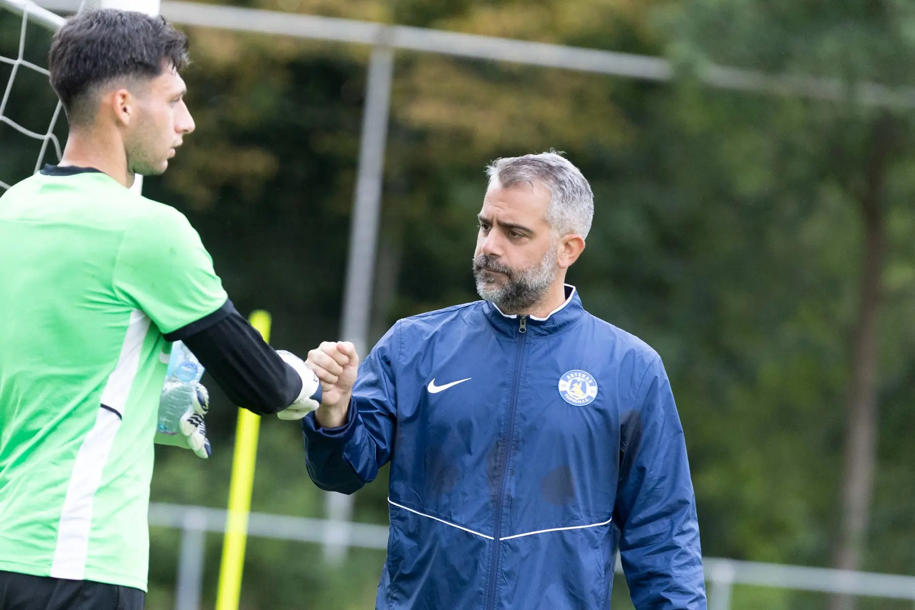 Panagiotis Pomonis greeting a goalkeeper during training